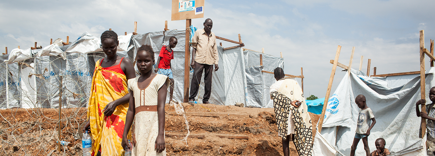 South Sudanese children walk around in a refugee camp